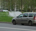 Water vapor from an open car hood on the road