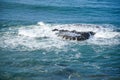 Water wave hitting giant rock in the sea Royalty Free Stock Photo