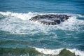 Water wave hitting giant rock in the sea Royalty Free Stock Photo