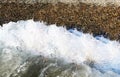 Water wave with pebble ashore Royalty Free Stock Photo