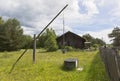 Water well on the background of an old house with boarded up windows Royalty Free Stock Photo