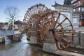 Water wheel in front of old town in China Royalty Free Stock Photo