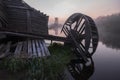 Water and windmill mill on the river early in the morning at dawn in a traditional Russian village. Rural autumn landscape Royalty Free Stock Photo