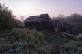 Water and windmill wooden mill on the river early in the morning at pink sunrise in a traditional Russian village. Rural autumn Royalty Free Stock Photo