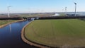 Water with windmills for green energy in the landscape. Countryside of Dinteloord.