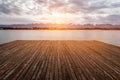 Water wooden pier on the lake at sunset time.