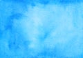 Watercolor calm blue background texture hand painted. Watercolour sky blue stains on paper