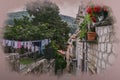 Watercolor effect of view of narrow street with stone buildings, flowers, laundry hanging and stairs in old town, Dubrovnik. Royalty Free Stock Photo