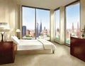 Watercolor of A furnished bedroom with a view of the city through the