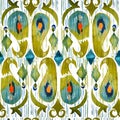 Watercolor green ikat vibrant seamless pattern. Trendy tribal in watercolour style. Peacock feather.