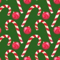 Watercolor hand drawn candy cane and red christmas ball seamless pattern on green background Royalty Free Stock Photo