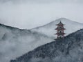 Watercolor hand drawn painting landscape pagoda mountain in the fog.