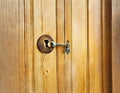 Watercolor of house key in front of a keyhole of a wooden door Royalty Free Stock Photo