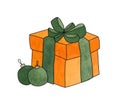 Orange gift box with a green bow and two Christmas balls Royalty Free Stock Photo