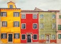 Watercolor image of row of bright colorful painted houses in Burano Venice
