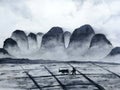 Watercolor landscape chinese mountain field with buffalo and farmer man in the countryside.traditional oriental ink asia art style