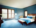 Watercolor of a master bedroom with a plush blue and soaring