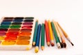 Watercolor paint, brushes, pencils well used on white background. Back to school, home schooling concept Royalty Free Stock Photo