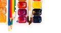 Watercolor paint, brushes, pencils well used on white background. Back to school, home schooling concept Royalty Free Stock Photo