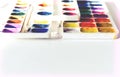 Watercolor paint and brushes well used on white wooden table with copy space for text Royalty Free Stock Photo