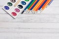 watercolor paint colored pencils wooden table art school drawing background image Royalty Free Stock Photo