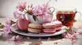 watercolor painting of a floral-infused cup of herbal tea and a macaron Royalty Free Stock Photo