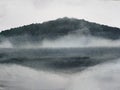 Watercolor painting ink landscape mountain reflect river in the fog.