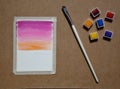 watercolor painting set with brush and colors swatches (taped down image illustration) cardboard artistic