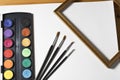 Watercolor painting set, wooden frame and brushes on white album background. Royalty Free Stock Photo