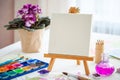 Watercolor paints, brushes , canvas on easel Royalty Free Stock Photo