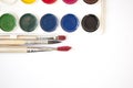 Watercolor paints and brushes, top view. Creative artistic mockup with copyspace Royalty Free Stock Photo