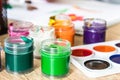 Watercolor paints and gouache in a jar on the table. Set for drawing, creativity and hobbies Royalty Free Stock Photo