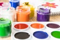 Watercolor paints and gouache in a jar on the table. Set for drawing, creativity and hobbies Royalty Free Stock Photo