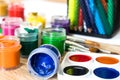 Watercolor paints and gouache in a jar on the table. Set for drawing, creativity and hobbies Royalty Free Stock Photo
