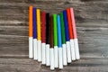 watercolor pens of different colors for painting on wooden background, back to school concept, school supplies and