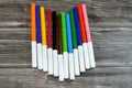 watercolor pens of different colors for painting isolated on wooden background, back to school concept, school supplies and