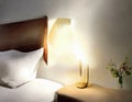 Watercolor of Scandinavian bedside lamp lighting up bedroom at