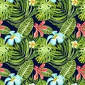 Watercolor seamless pattern with exotic plants, flowers and leaves on dark blue background. Summer tropical print. Green palm leaf Royalty Free Stock Photo