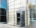 Watercolor of a sleek metal mailbox in front of a modern glass building