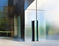 Watercolor of a sleek metal mailbox in front of a modern glass building