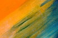 Watercolor smears on the canvas: orange, blue, green