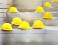 Watercolor of stack of yellow hard hats on a construction site