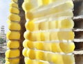 Watercolor of stack of yellow hard hats on a construction site