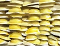 Watercolor of stack of yellow hard hats on a construction site