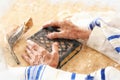 Watercolor style and abstract image of Old Jewish man hands holding a Prayer book. Jewish traditional symbols.