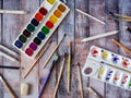 Watercolors, palette, art brushes and other items for painting on a table