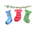 Watercolour colourful socks for presents on tree branch.