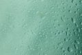 Waterdrops on glassplate with lightgreen background