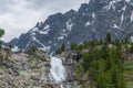 Waterfall against the backdrop of mountains in the Altai Mountains