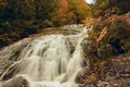 Waterfall in the autumn forest in the mountains. Royalty Free Stock Photo